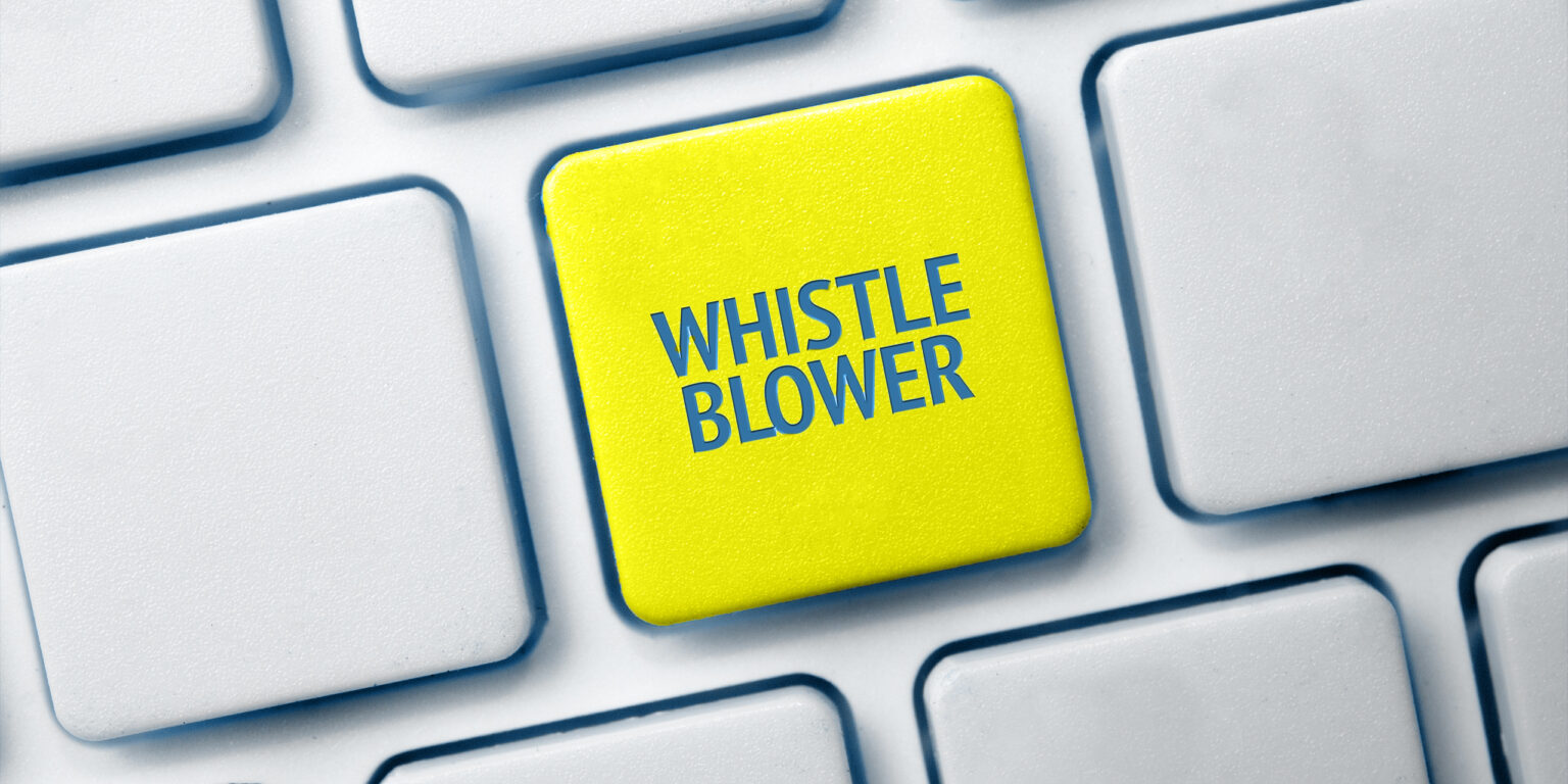 Whistleblowing concept: White keyboard with a red key and the whistleblower word